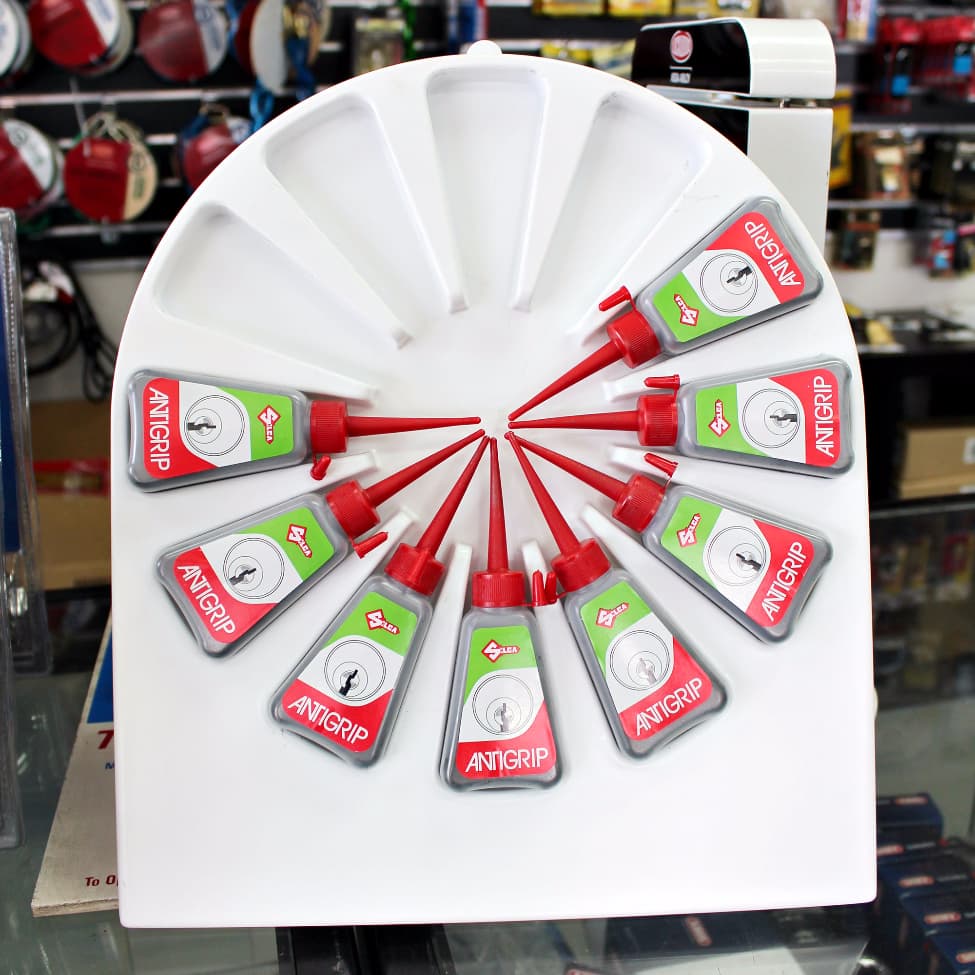 Display of Antigrip products on a white wheel in a store setting