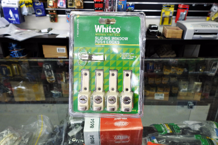 Packaged Whitco sliding window bush locks on a store shelf.