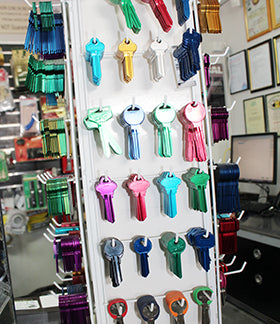 Colorful key blanks on a display board in a store.